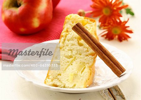 apple pie with cinnamon stick on a white plate