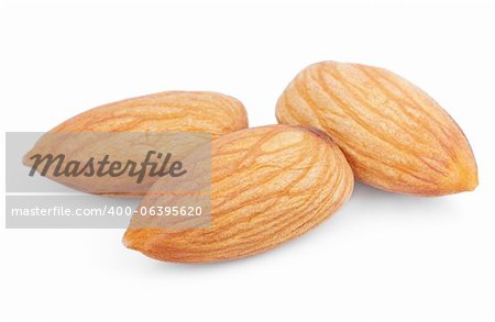 Closeup of three almond nuts isolated on white