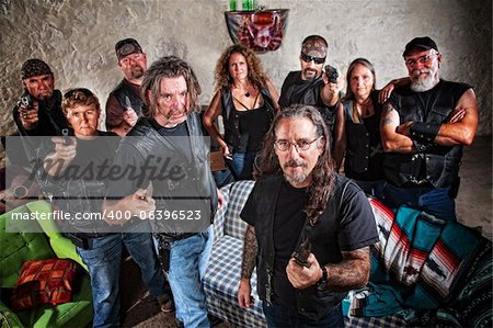 Group of nine biker gang members in leather jackets indoors