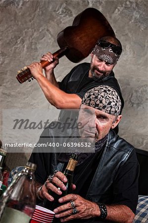 Gang member with guitar about to attack man sitting