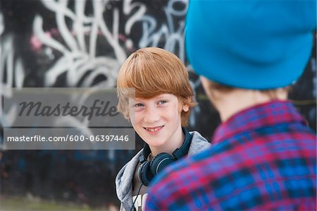 Boys Outdoors by Graffiti Covered Wall, Mannheim, Baden-Wurttemberg, Germany Boys Outdoors by Graffiti Covered Wall, Mannheim, Baden-Wurttemberg, Germany
