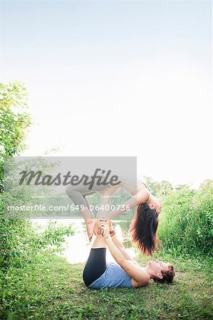 Couple practicing yoga in garden