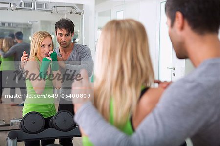 Boxer practicing with trainer in gym