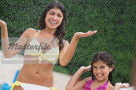 Sisters playing in water outdoors