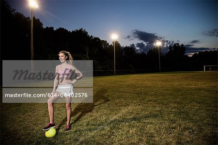 Girl on soccer pitch at night