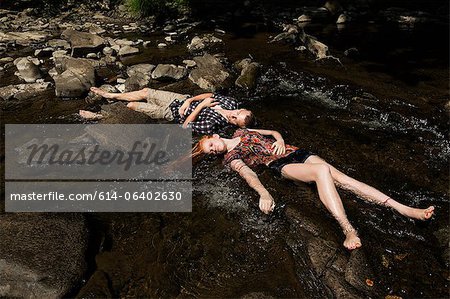 Couple lying down in river