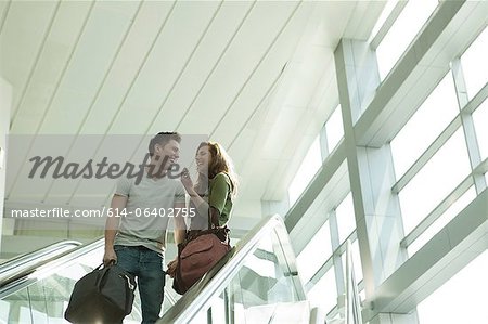 Young couple travelling on escalator