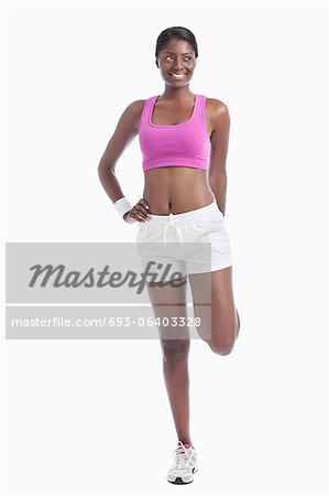 Young African American Woman exercising over white background
