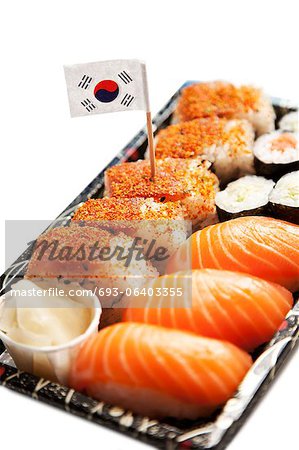 Sushi food on tray with Korean flag against white background