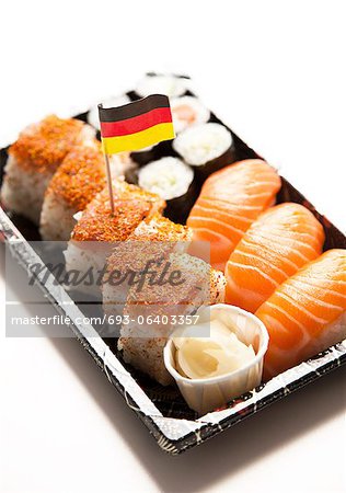Sushi food on tray with German flag against white background Sushi food on tray with German flag against white background