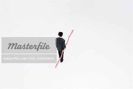 Businessman with arrow pointed upward projecting financial growth