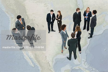 Executives chatting while standing on map of the United States