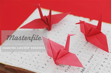 Origami of cranes on a traditional Japanese music sheet
