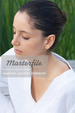 Young woman meditating with eyes closed, portrait