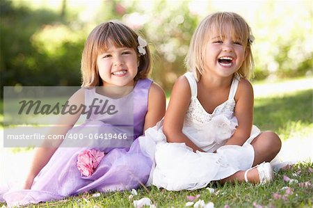 Two young girls posing in park