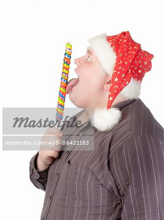 Cheerful obese man in a red Santa hat chewing on a long colourful spiral lollipop with a grin on his face isolated on white