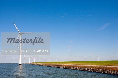 Wind turbines along the dike in the IJsselmeer in Flevoland, the Netherlands