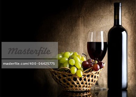 Flasche Rotwein und Trauben auf eine Hintergrund-Leinwand