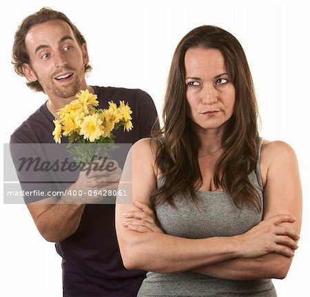 Skeptical female with smiling young man holding flowers