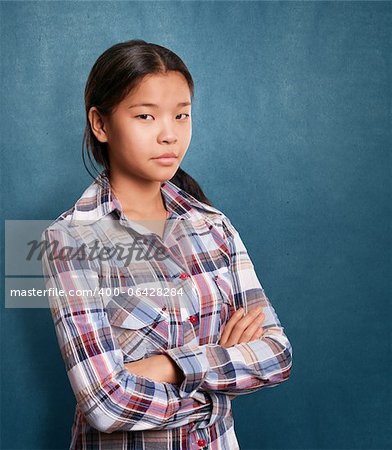 Asian girl looking on camera with folded hands