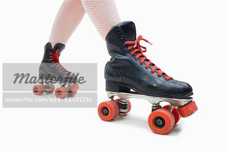 Woman Wearing Fishnet Stockings and Old Fashioned Roller Skates