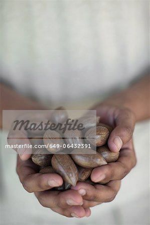 Close up of hands holding nuts