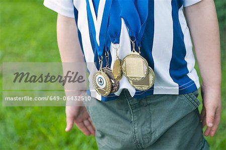 Close up of boy wearing medals