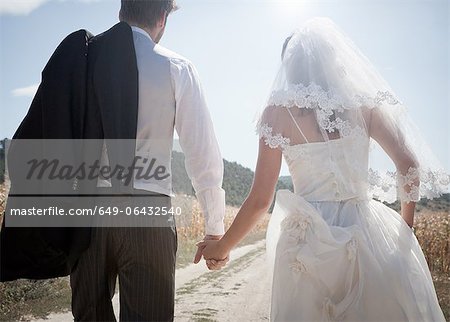 Newlywed couple walking outdoors