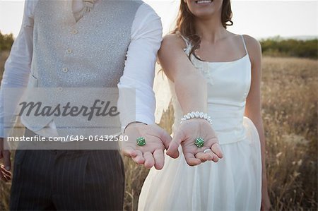 Newlywed couple holding green dice