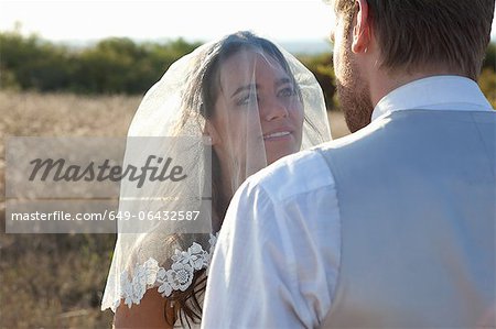Newlywed couple standing outdoors