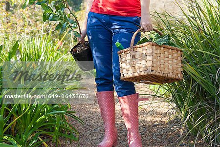 Woman carrying vegetables and plant