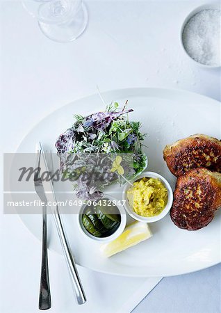 Plate of fish with herb salad