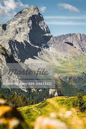 Rocky mountains over grassy landscape