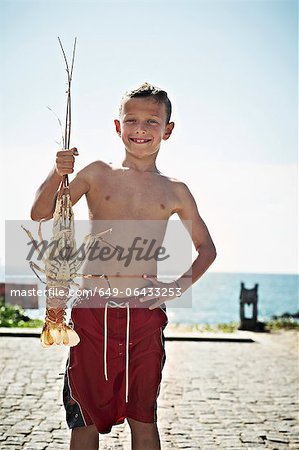 Boy holding freshly caught lobster