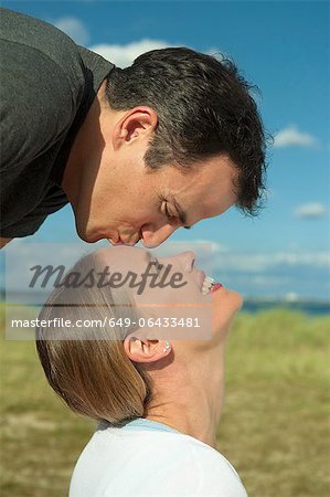 Man kissing girlfriend outdoors