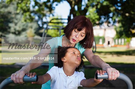 Woman and granddaughter playing in park
