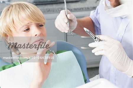 Boy declining Needle at Dentist's Office during Appointment, Germany
