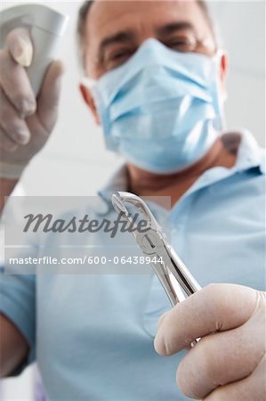 Close-up of Dental Instrument held by Dentist in Dental Office, Germany