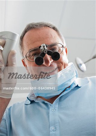 Close-up of Dentist with Magnifier on Eyeglasses in Dental Office, Germany