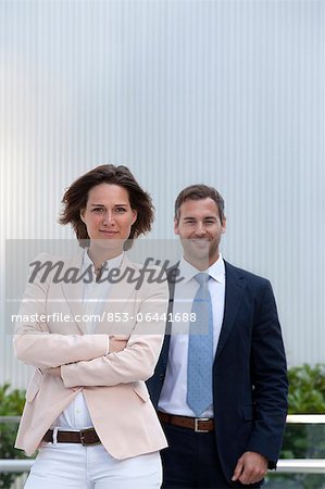 Confident businesswoman and businessman outdoors