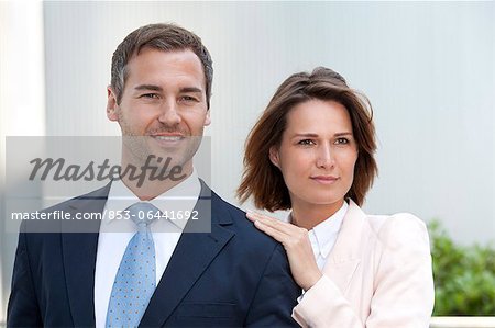 Businesswoman laying her hand on the shoulder of a businessman