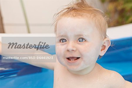 Female baby in inflatable swimming pool