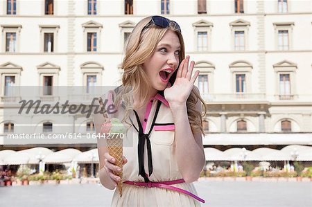 Young woman with ice cream cone, shouting