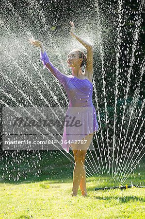 Ballerina in water sprinkler