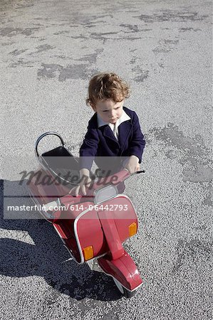 Little boy with red scooter