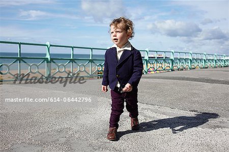 Little boy walking promenade in mod clothing