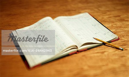 Open account book on wooden desktop