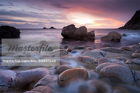 Sunset over the Brisons and Porth Nanven, a rocky cove near Land's End, Cornwall, England, United Kingdom, Europe