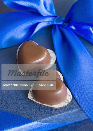 Blue gift box and heart-shaped chocolates Blue gift box and heart-shaped chocolates
