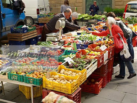 vendors sell vegetables at village farmers market, Cortona, Tuscany, Italy